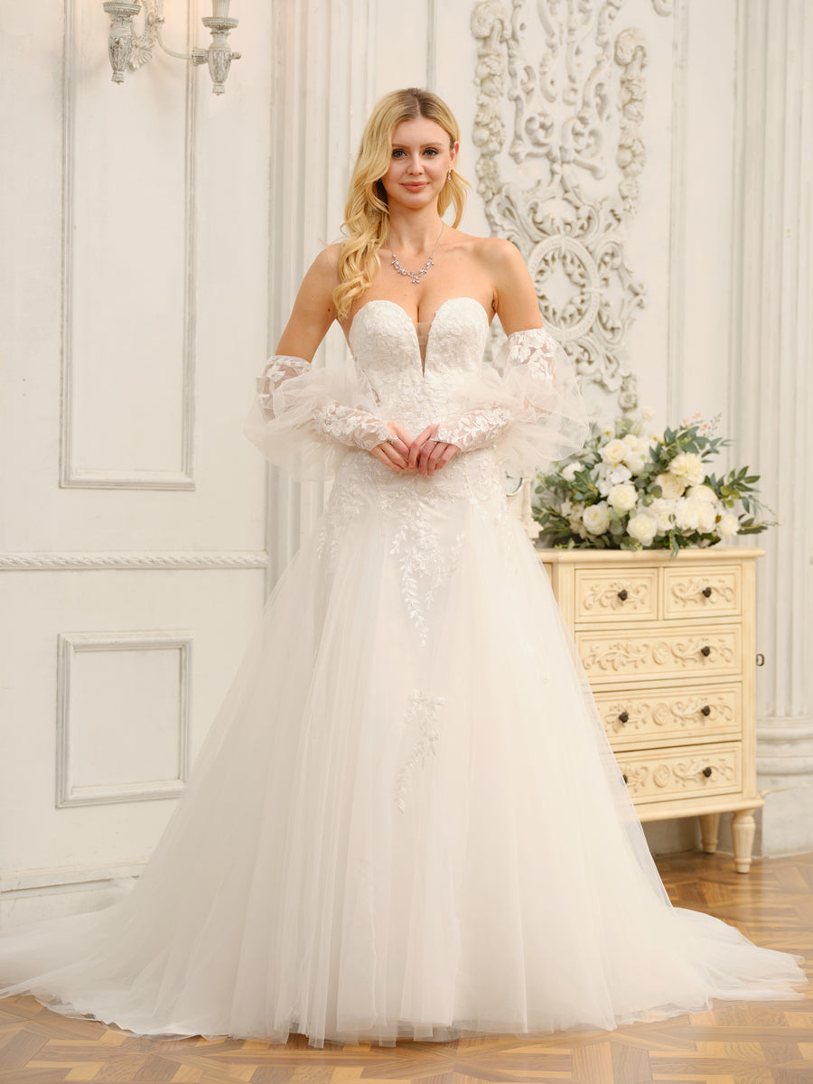 Bride wearing an elegant A-line sweetheart wedding dress with intricate appliques.