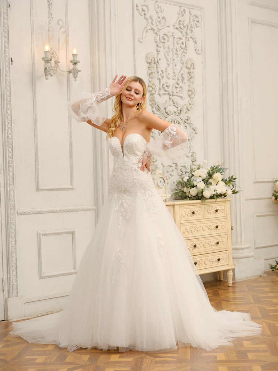 Back view of the A-line wedding dress, showcasing the flowing train and applique details.