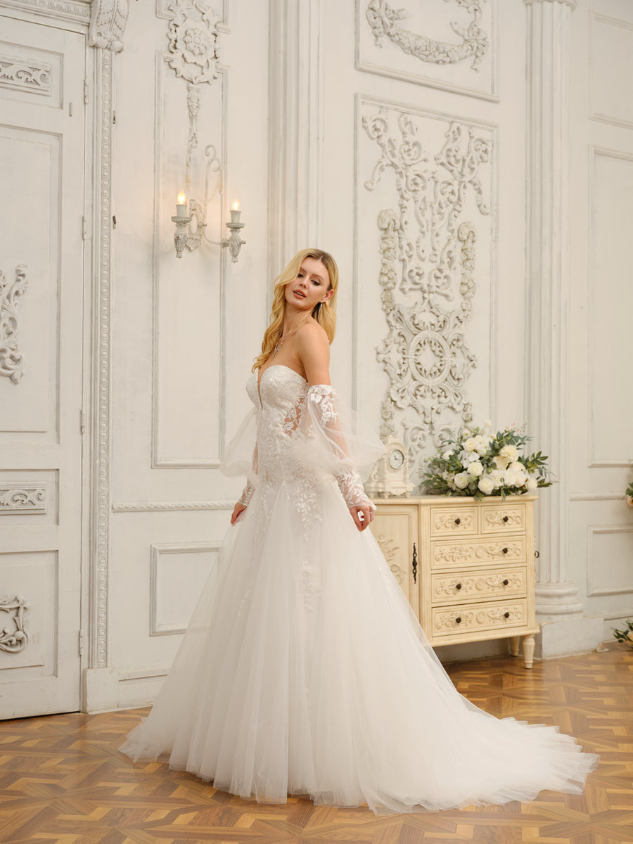 Detailed view of the exquisite floral appliques on the wedding gown.