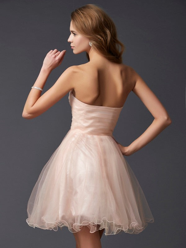Model wearing a Weitese A-line sweetheart short silk-like satin homecoming dress, side view.