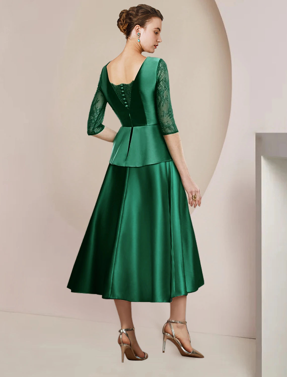 Back view of the A-line tea-length dress showing satin lace and ruching details.