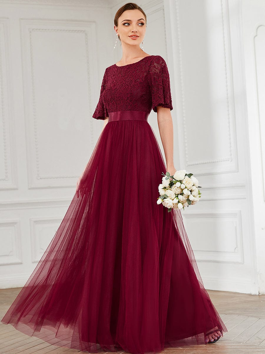 Elegant A-line tulle bridesmaid dress with short sleeves and ribbon waist, front view.