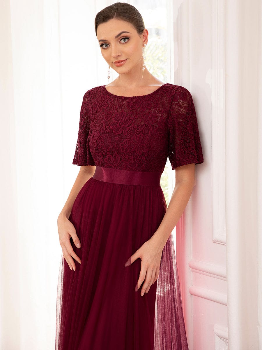 Backless A-line tulle dress with ribbon waist detail, rear view.