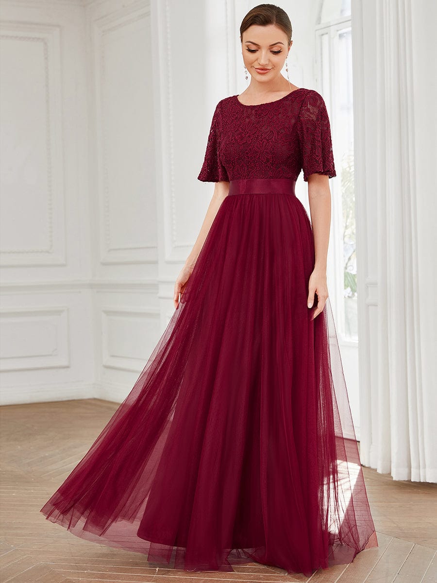 Full length view of a short sleeve tulle bridesmaid dress.
