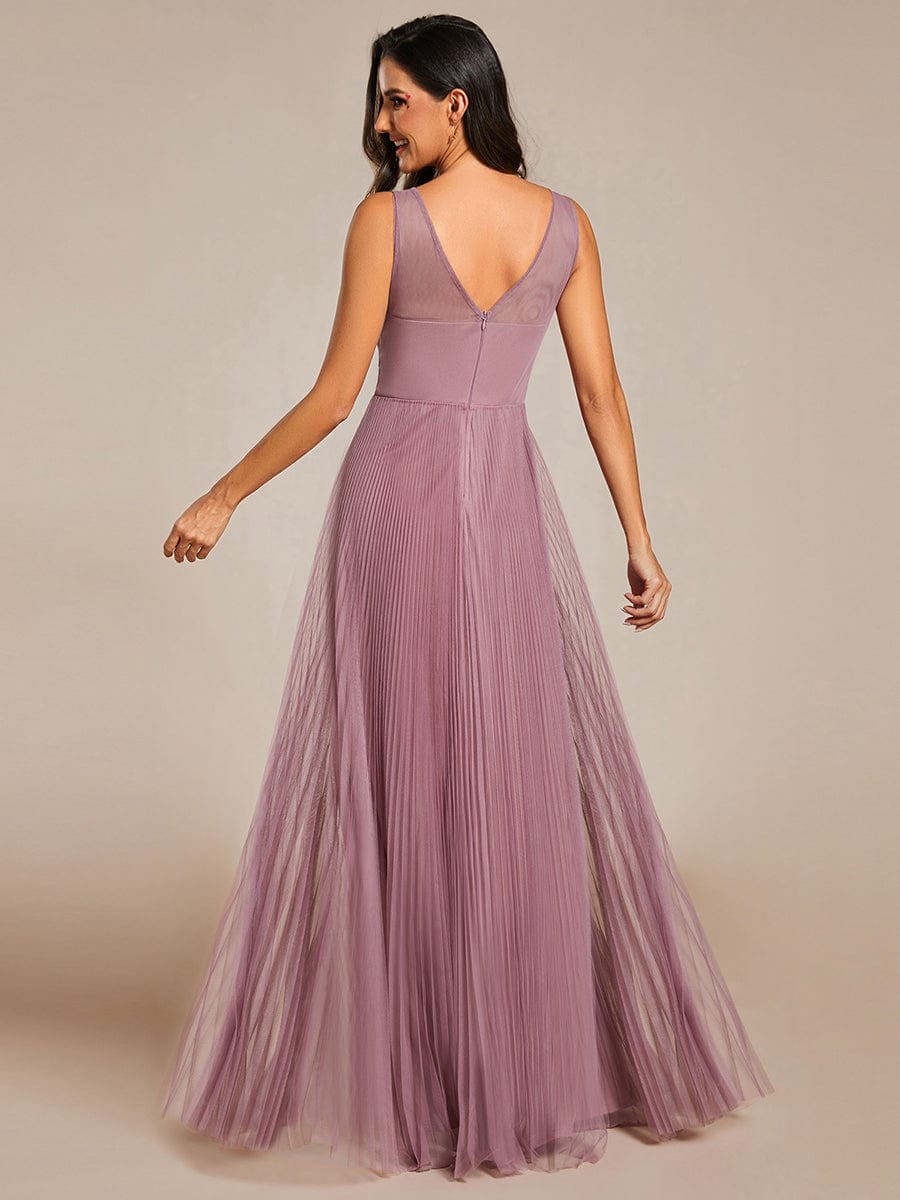 Full length view of a model in a red sleeveless A-line tulle evening dress.
