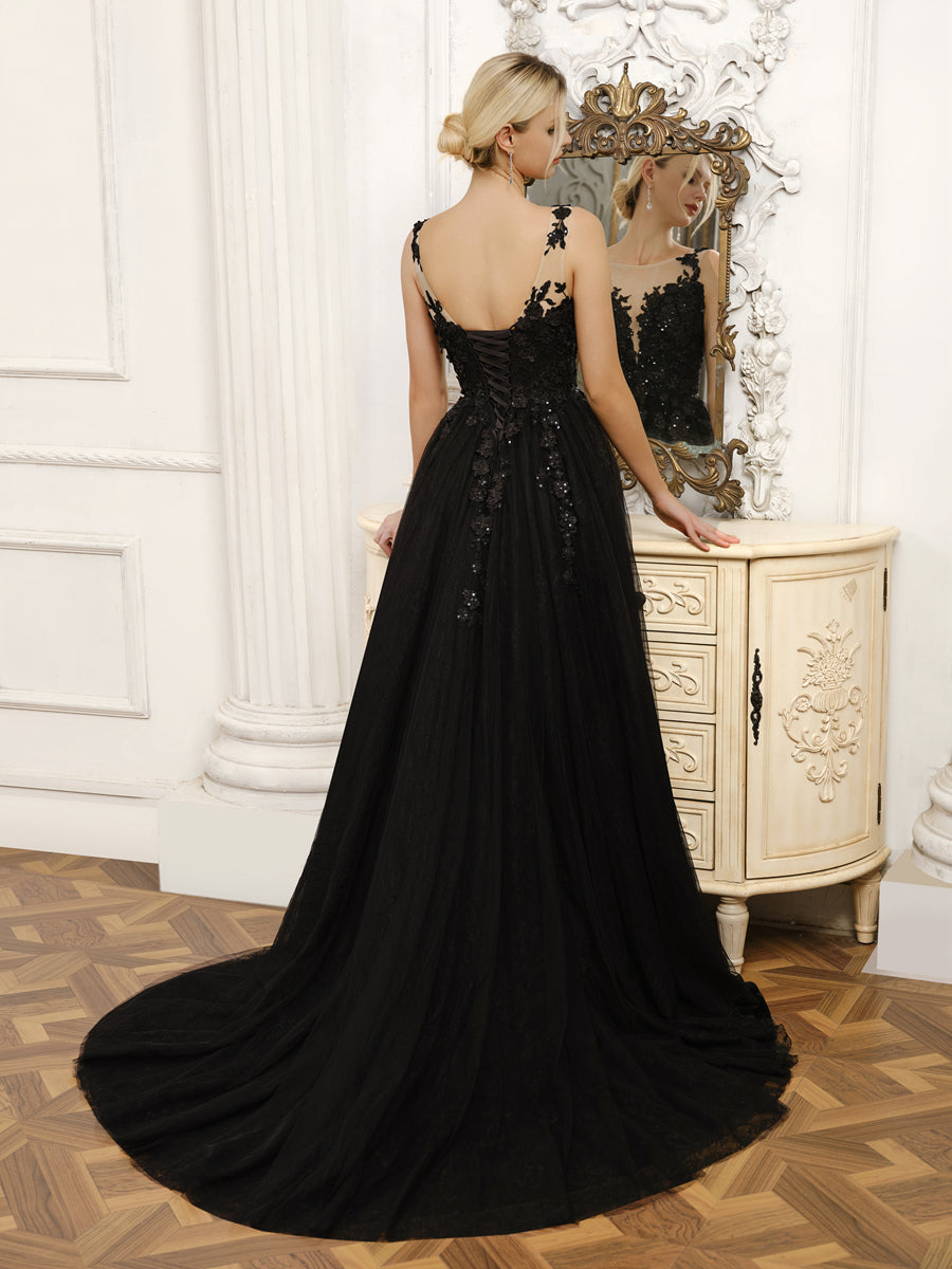 Side view of the elegant A-line tulle wedding dress, showcasing the flowing skirt and split.