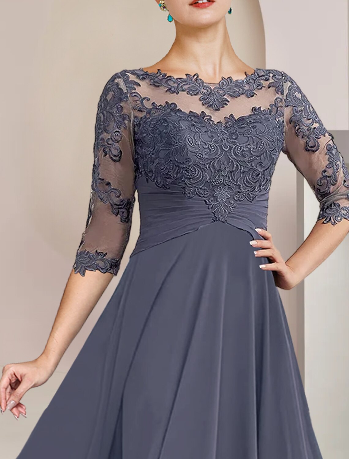 Close-up of chiffon and lace details on the mother of the bride dress.