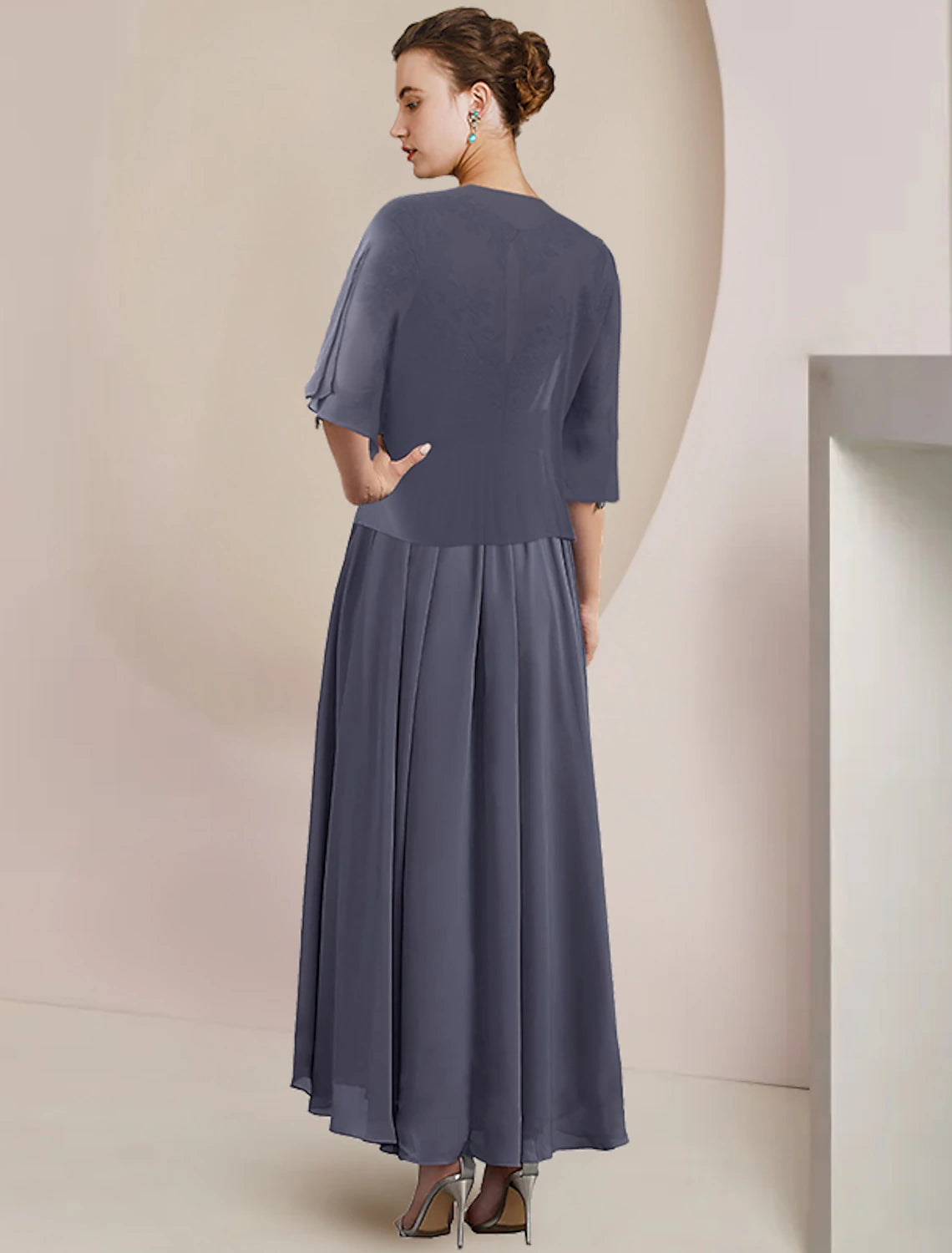 Model wearing the two-piece mother of the bride dress with included wrap.
