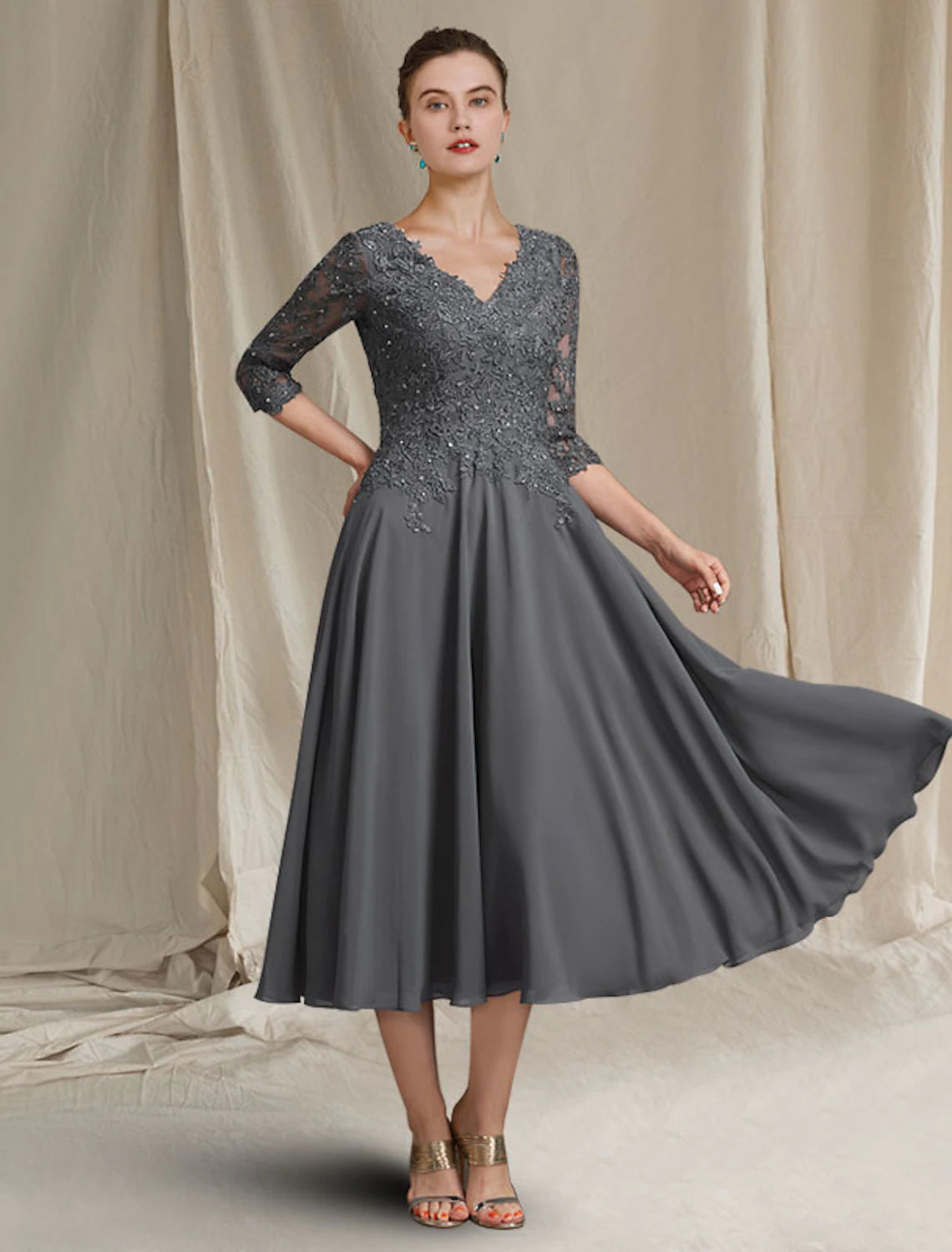 Elegant A-line V-neck tea length Mother of the Bride dress with 3/4 lace sleeves.