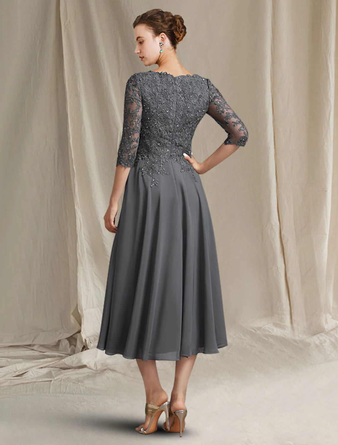 Side view of A-line Mother of the Bride dress, showcasing chiffon skirt and lace bodice.