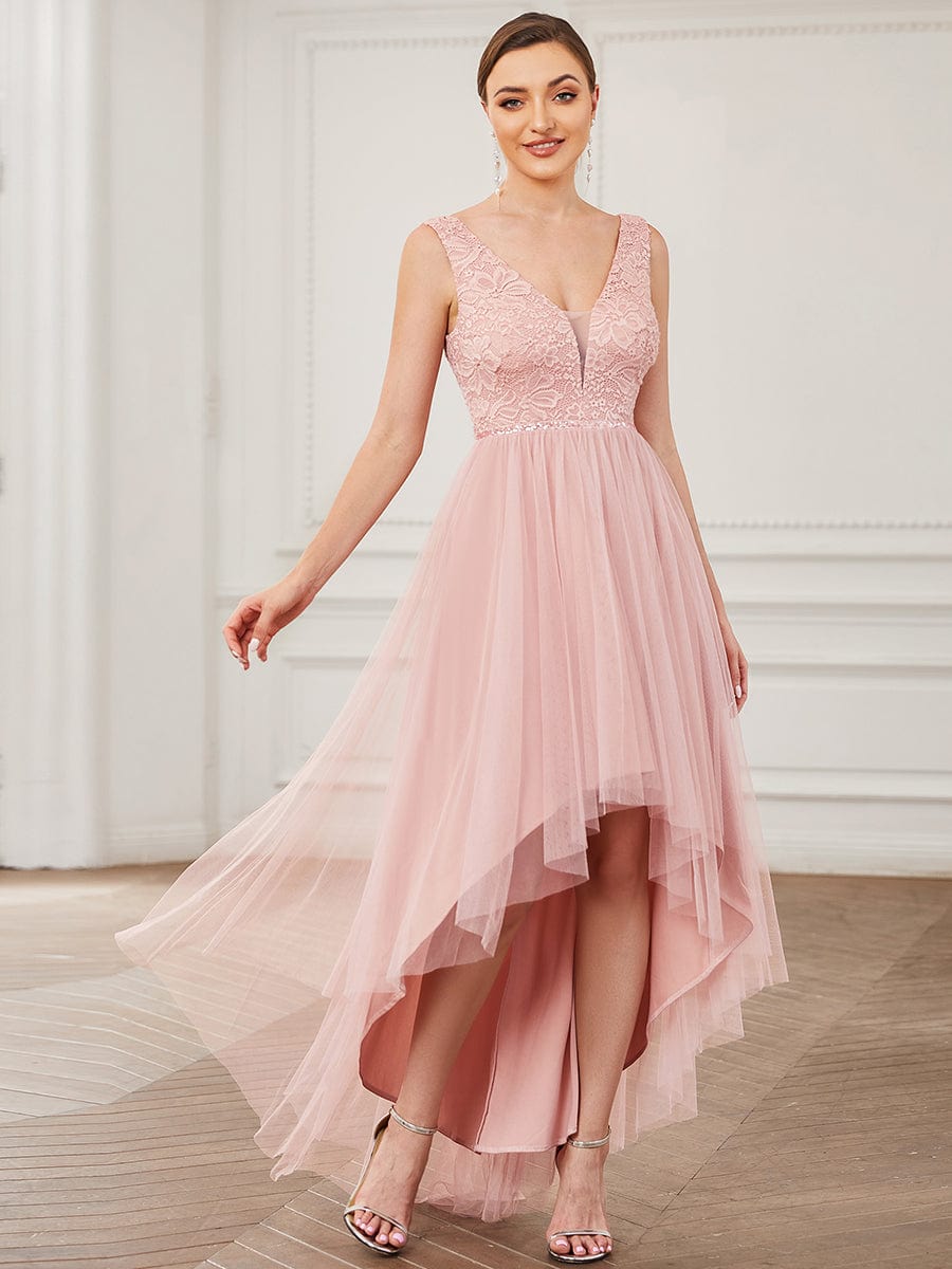Model wearing an elegant blush pink lace V-neck backless high-low bridesmaid dress, front view.