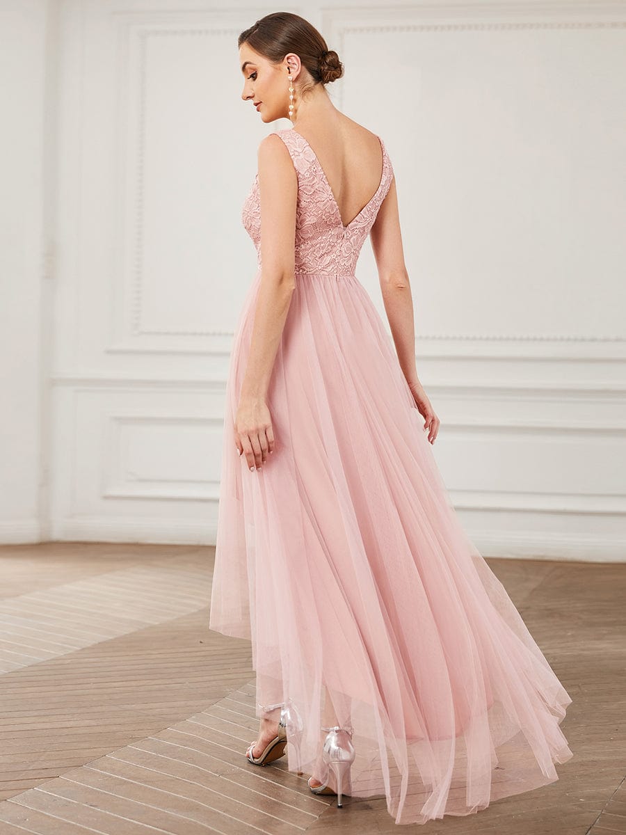 Model wearing an elegant blush pink lace V-neck backless high-low bridesmaid dress, side view.