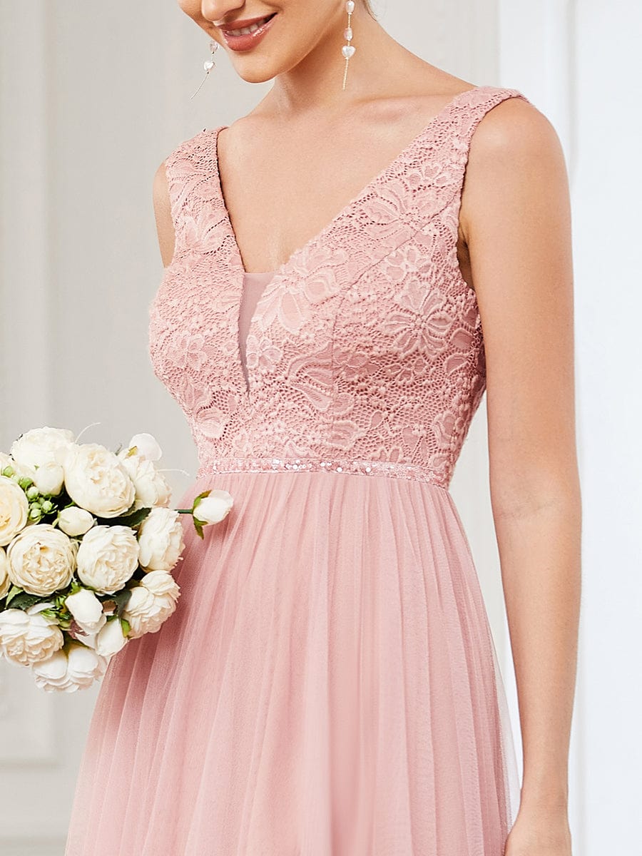 Close-up of the delicate lace detail on the blush pink V-neck bridesmaid dress.