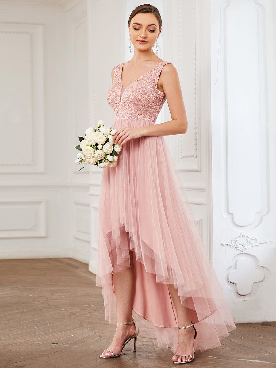 Model wearing an elegant blush pink lace V-neck backless high-low bridesmaid dress, back view.