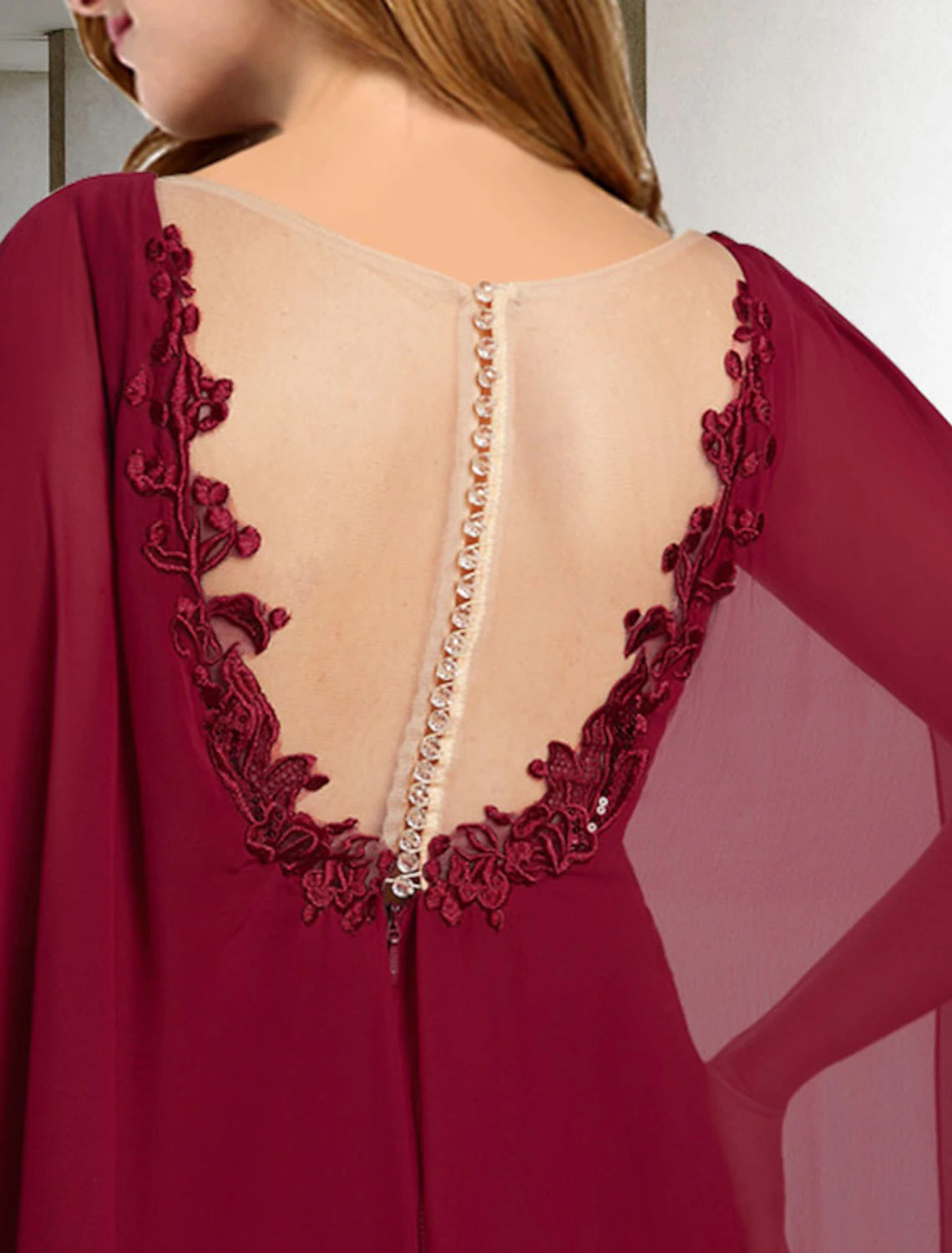 Back view of the elegant plus size Mother of the Bride gown with a sweep train.