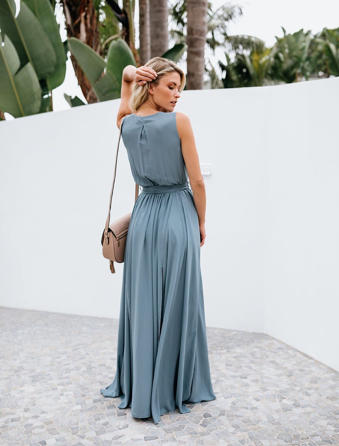 Model posing in the floor-length A-line chiffon bridesmaid dress, showcasing the slit and pleats.