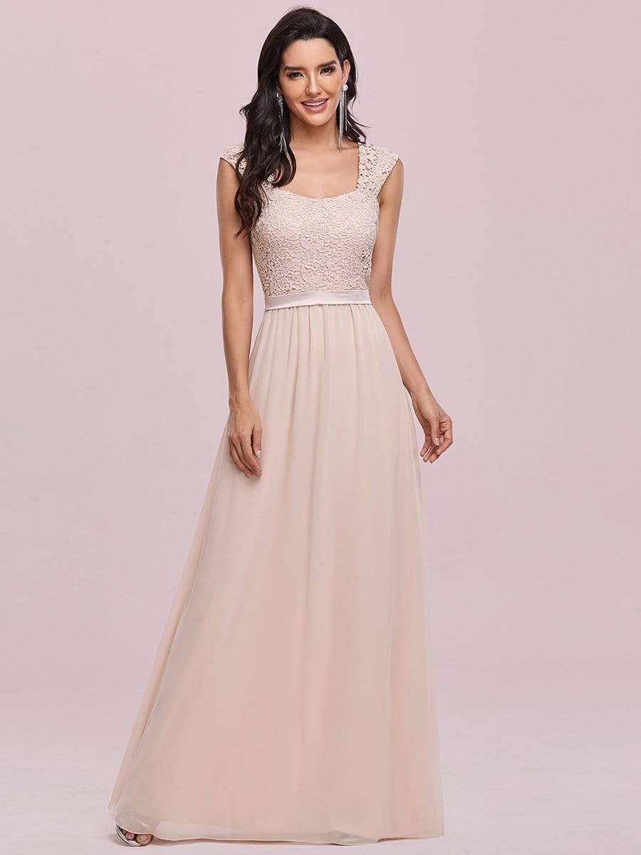 Model wearing a blue A-line chiffon bridesmaid dress with lace bodice.