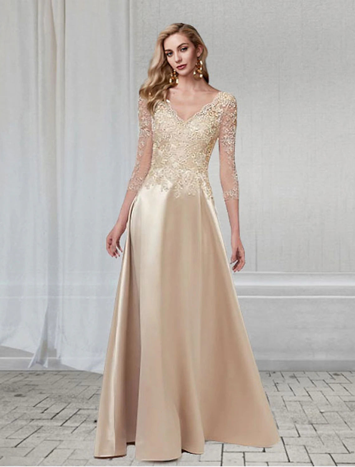 Model wearing an elegant A-line V-neck chiffon gown with appliques and 3/4 sleeves.