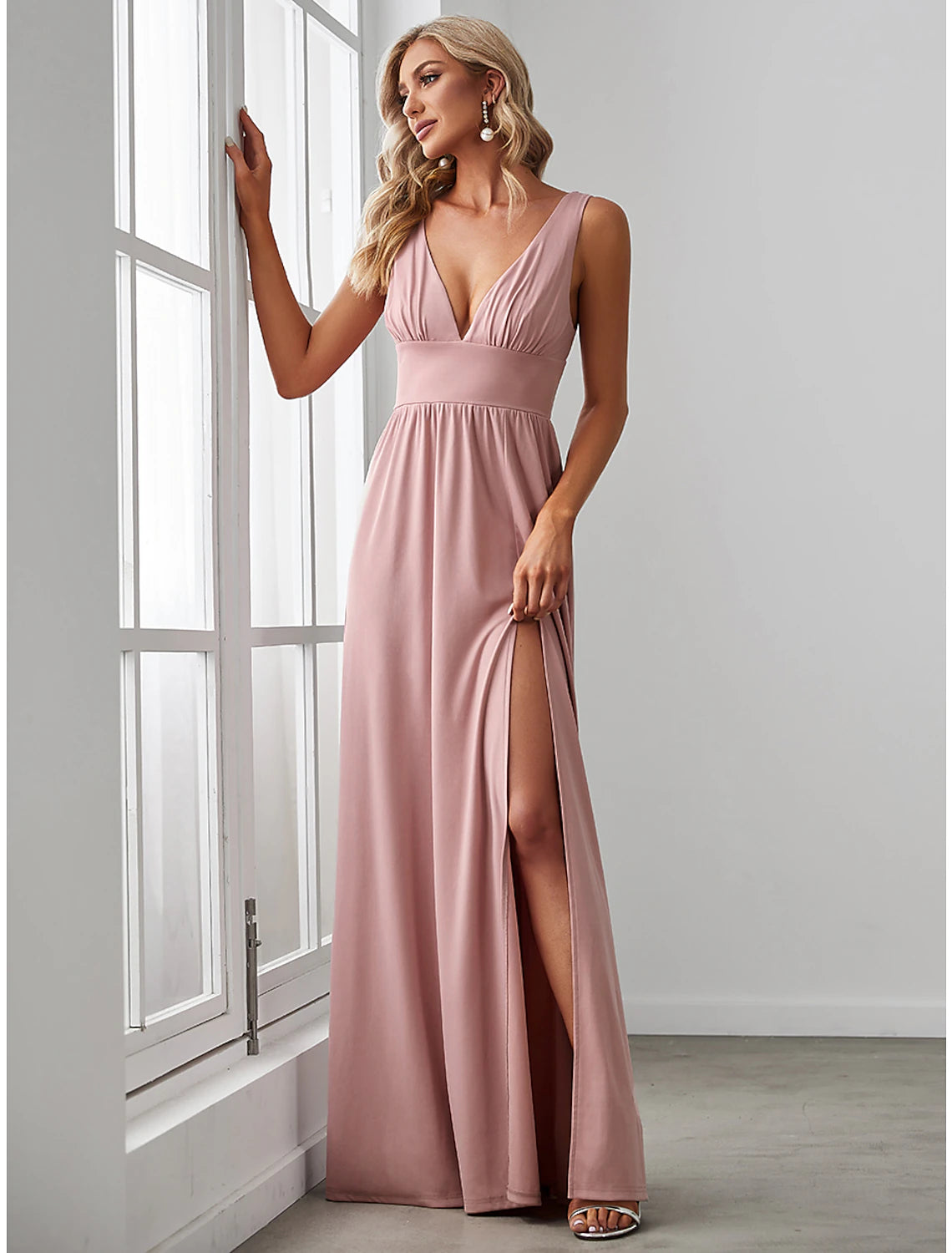 Full length view of a woman in a formal A-line V-neck chiffon dress.