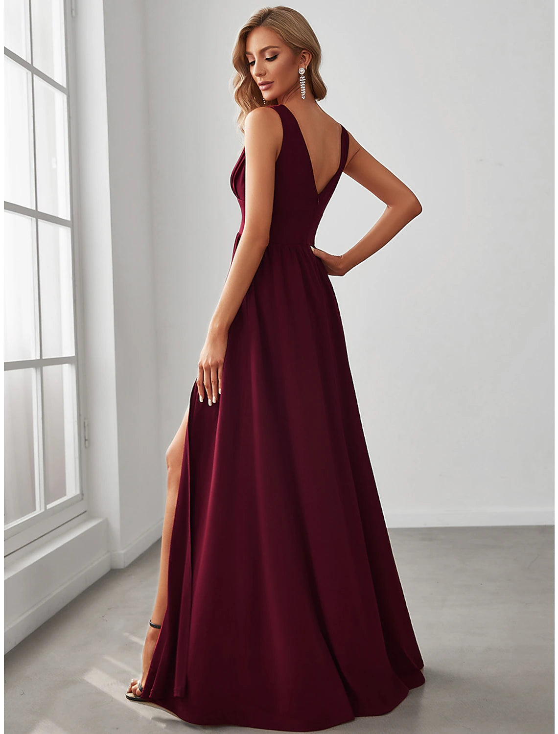 Close-up of the V-neckline and bodice of an A-line chiffon formal gown.