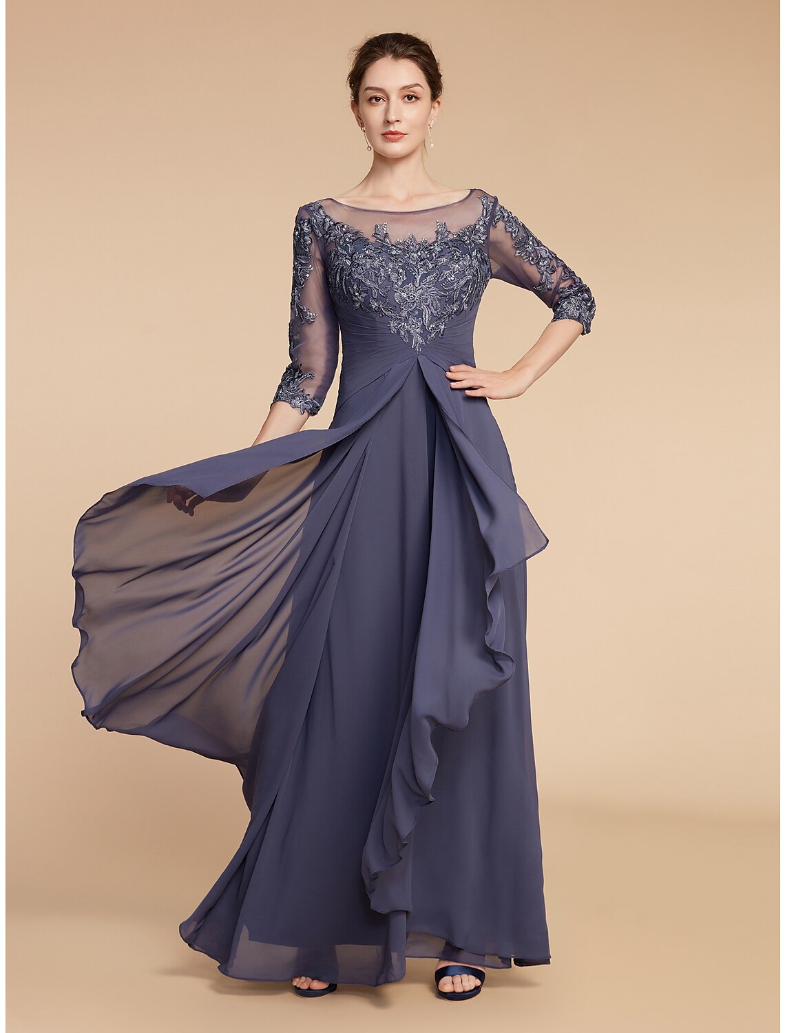 Woman wearing an elegant A-line V-neck mother of the bride dress with 3/4 sleeves and appliques.