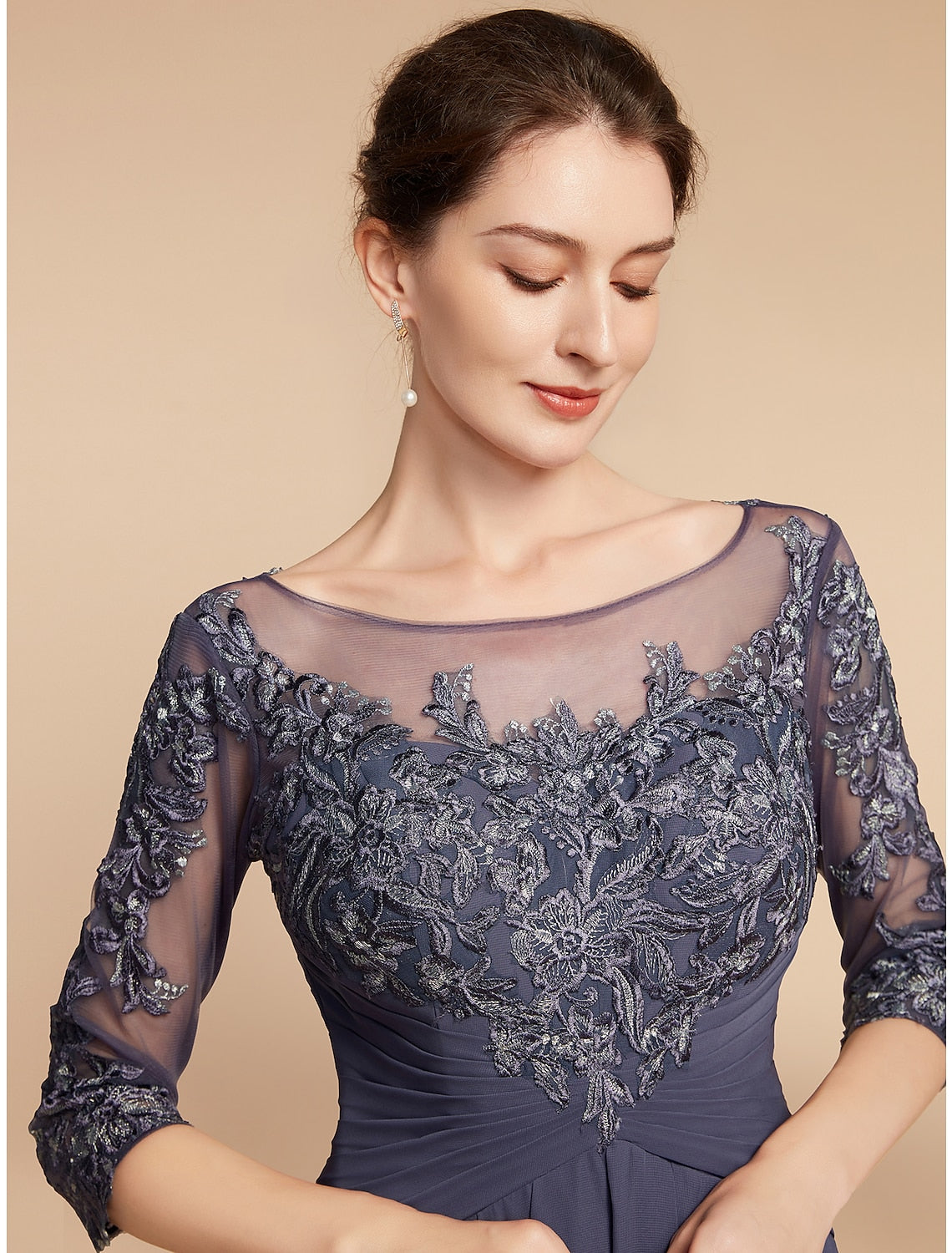 Woman posing in the floor-length A-line dress, showcasing its elegant flow.
