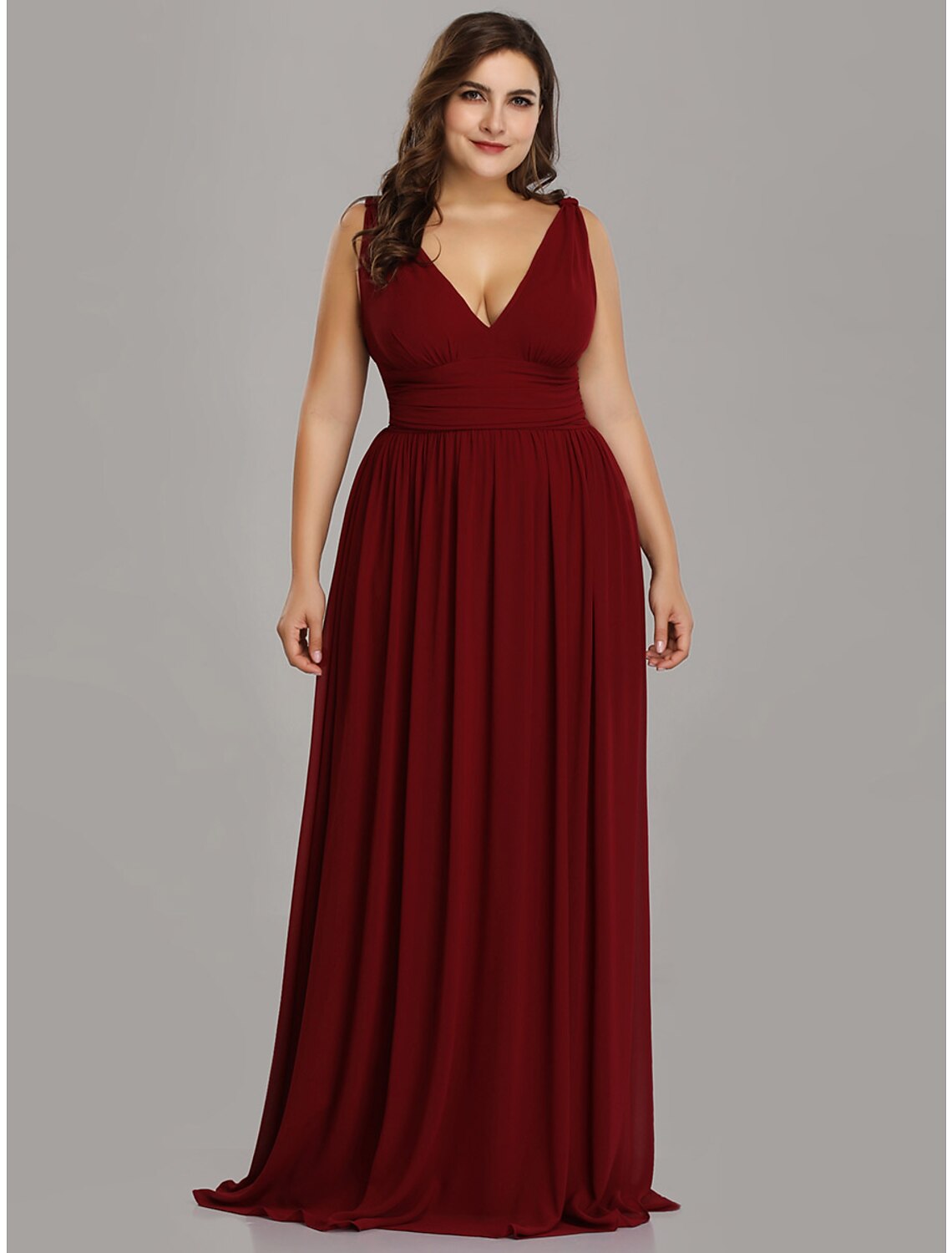 Model wearing a dark A-line V-neck pleated chiffon gown.