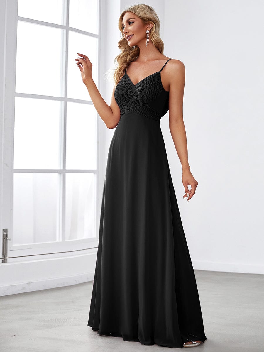 Close-up of V-neckline and chiffon fabric on black dress.
