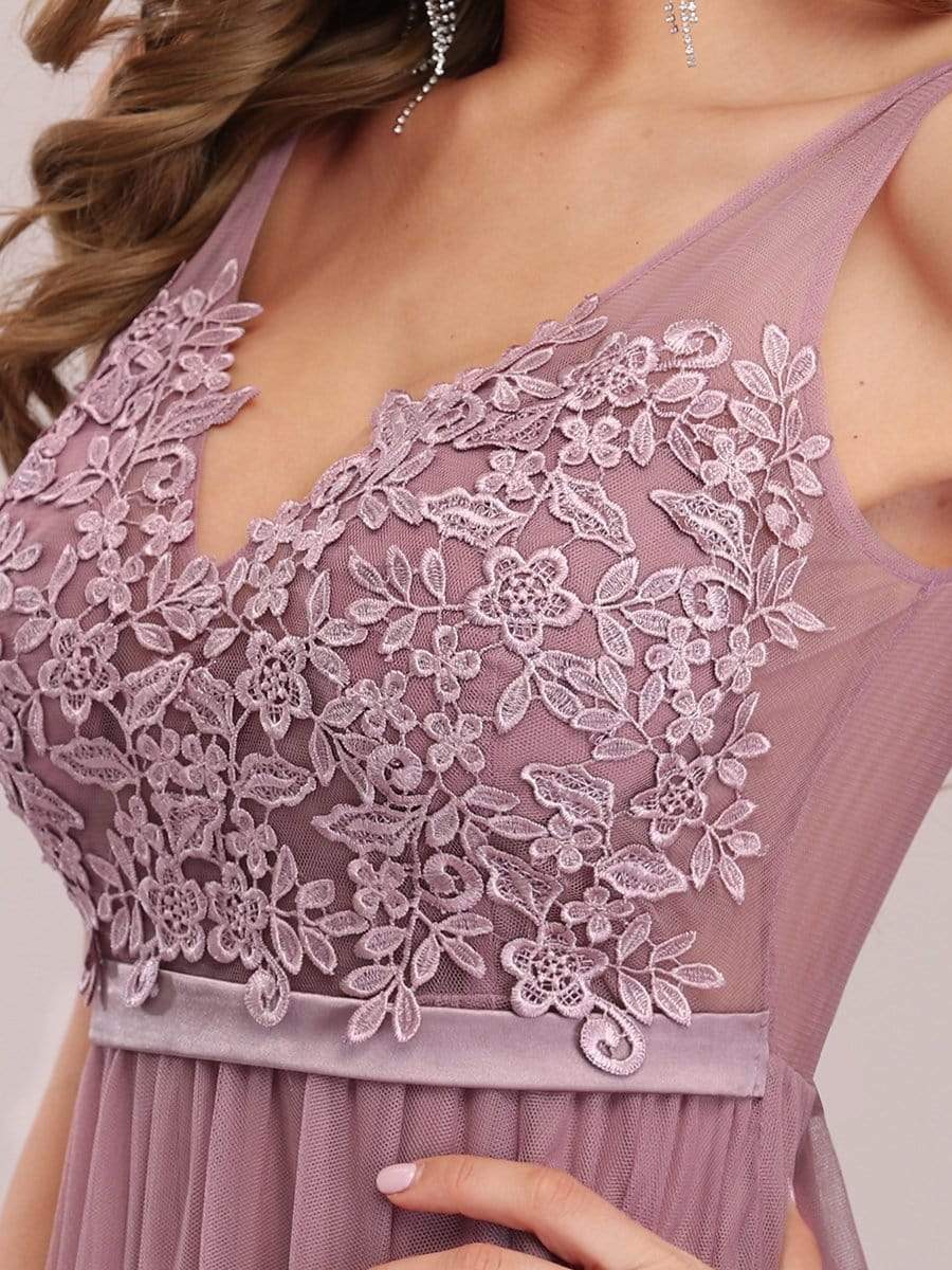 Model wearing a pink A-line V-neck floral lace bridesmaid dress.