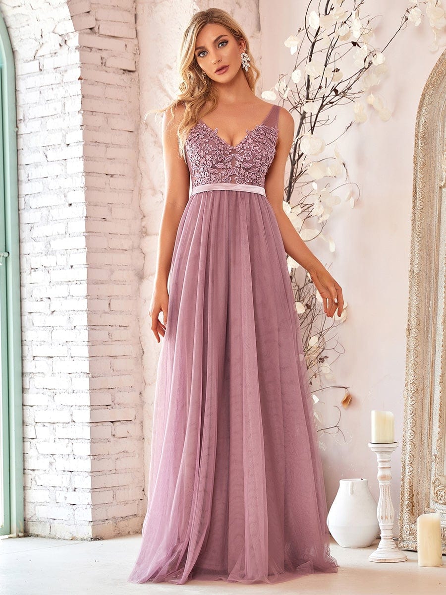 Model wearing a purple A-line V-neck floral lace bridesmaid dress.