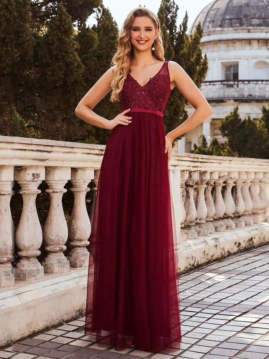 Model wearing a burgundy A-line V-neck floral lace bridesmaid dress.