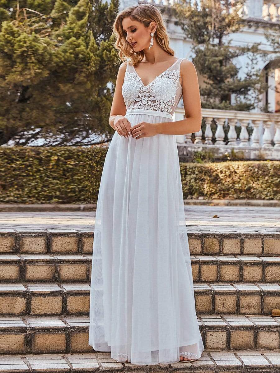 Model wearing a coral A-line V-neck floral lace bridesmaid dress.