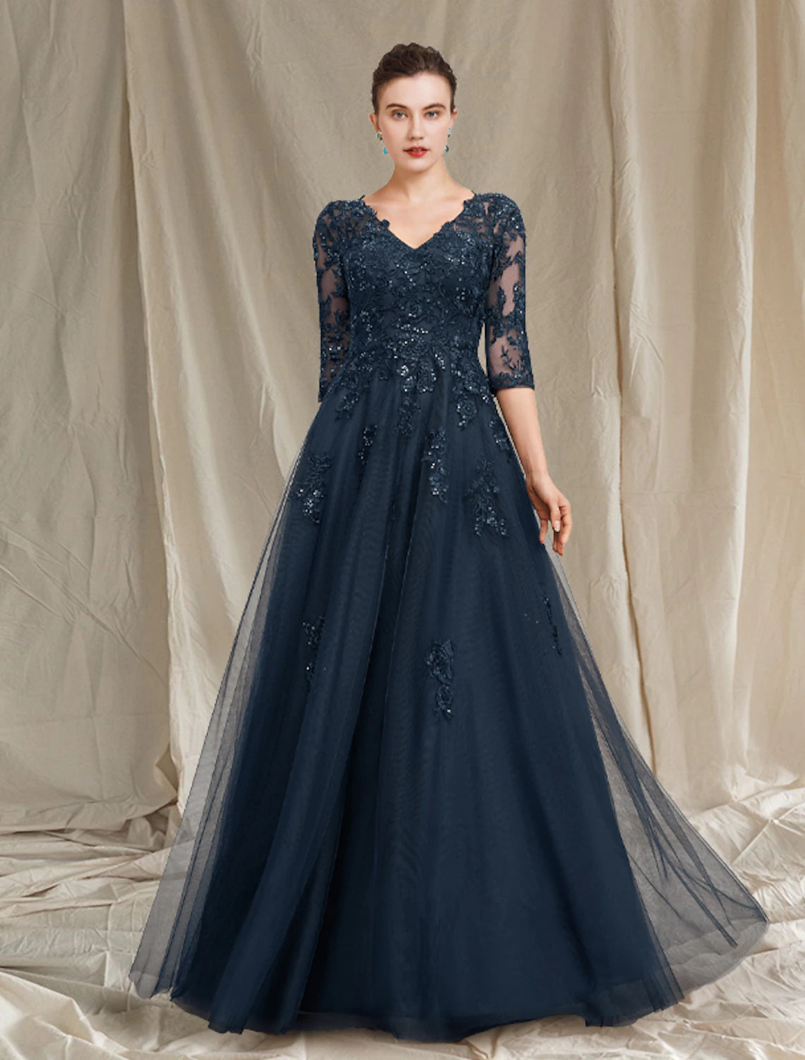 A-line mother of the bride gown with V-neck, half sleeves, and sequin details.