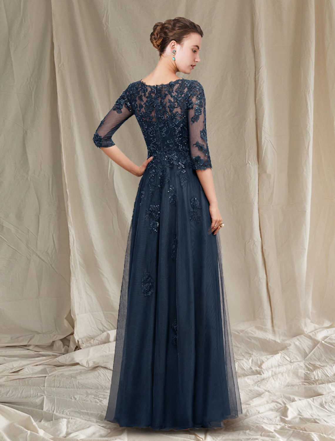 Close-up of sequin appliques and lace detail on a chiffon mother of the bride dress.