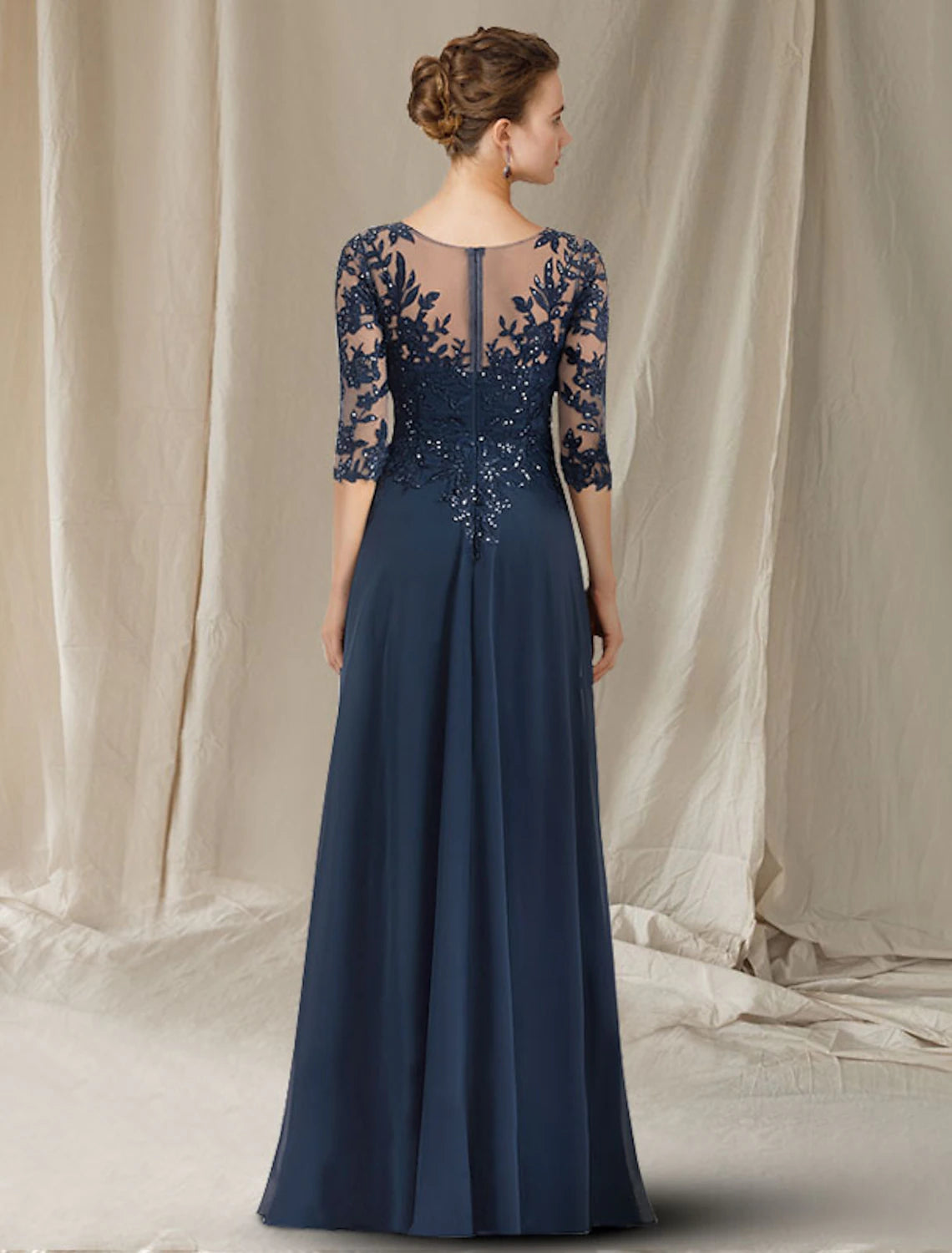 Close-up of the sequined lace and chiffon fabric on the elegant A-line dress.