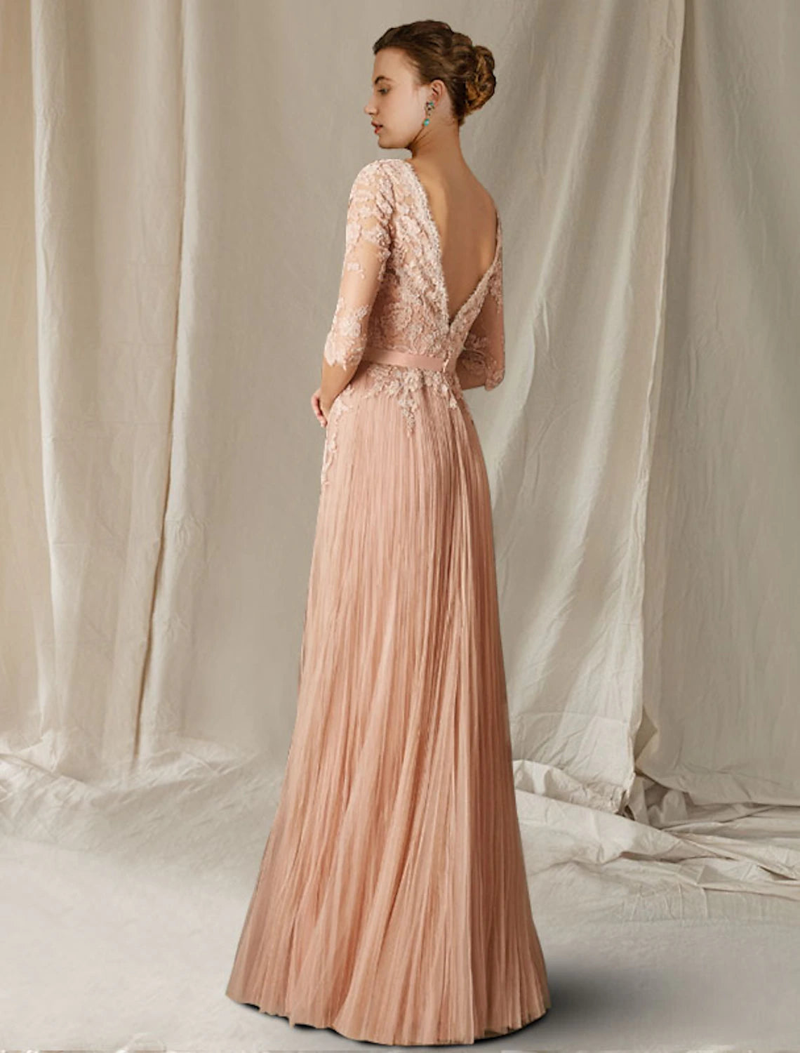 Close-up of the lace and tulle fabric with pleat details on the elegant A-line gown.