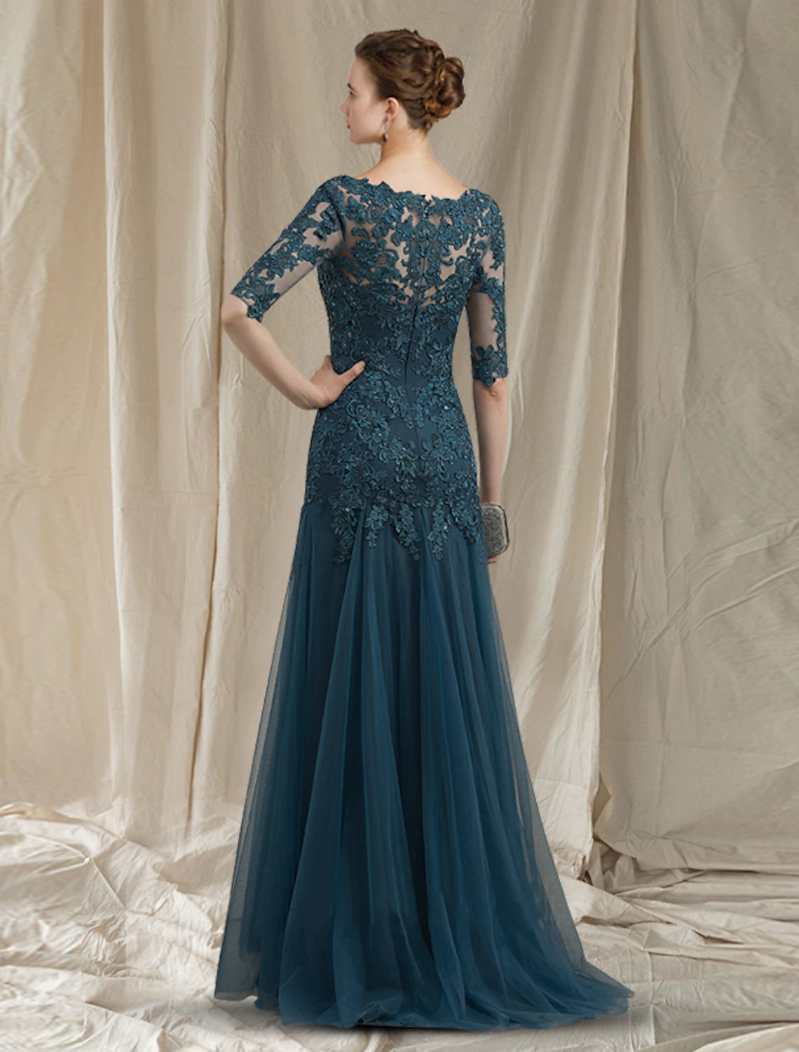 Close-up of delicate lace and applique details on the dress.
