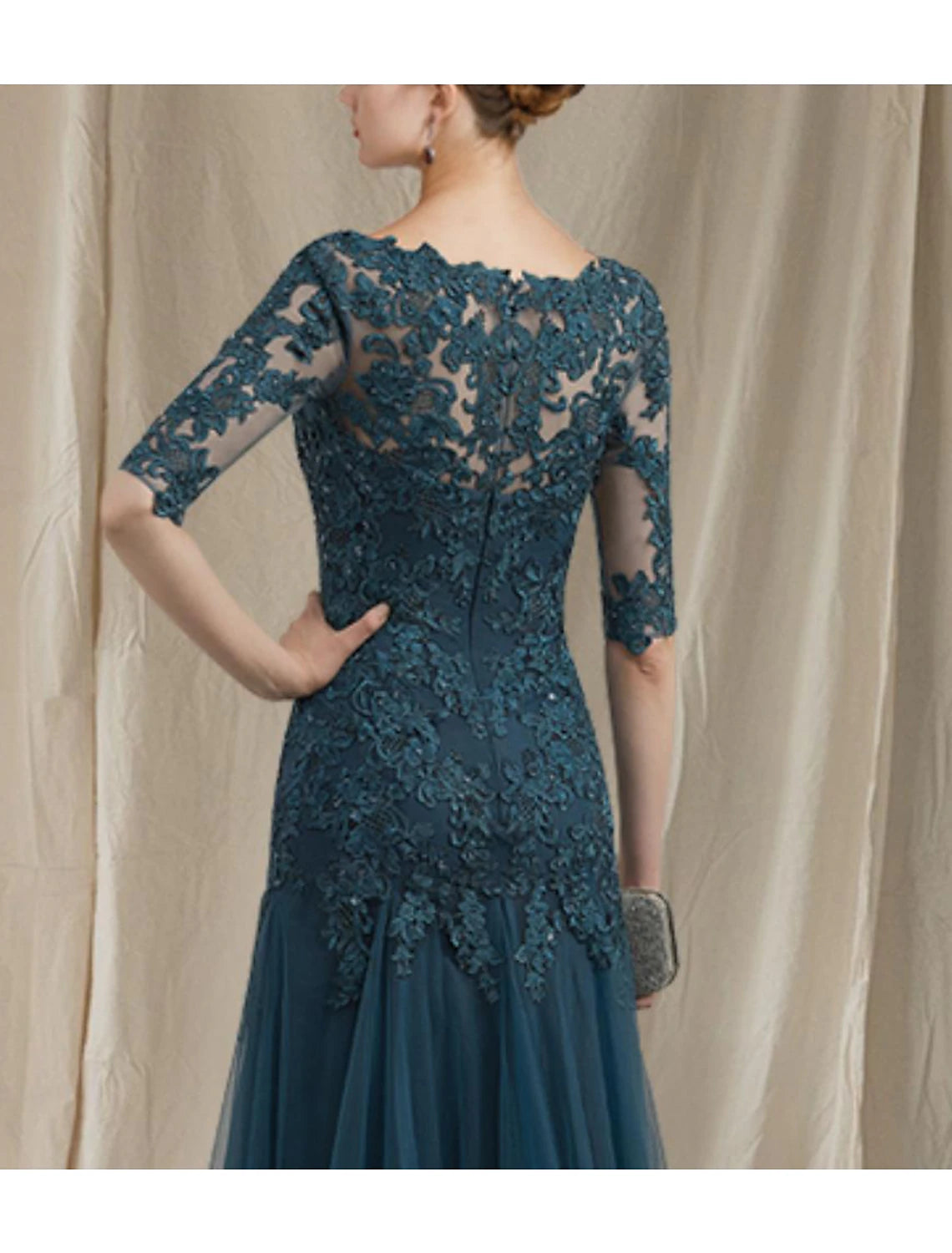 Side profile of the elegant Mother of the Bride dress.