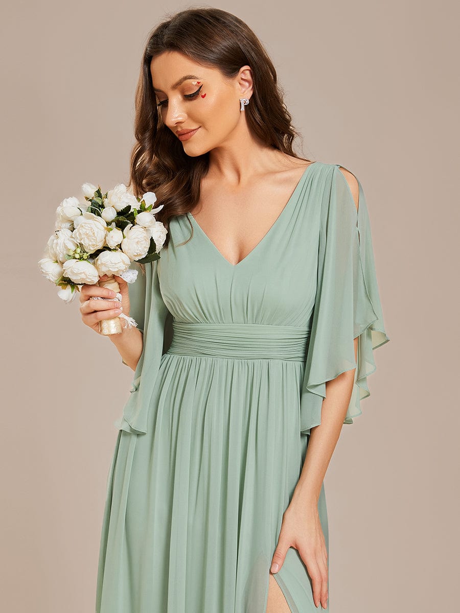 Close-up of the pleated bodice and V-neckline of the green chiffon bridesmaid dress.