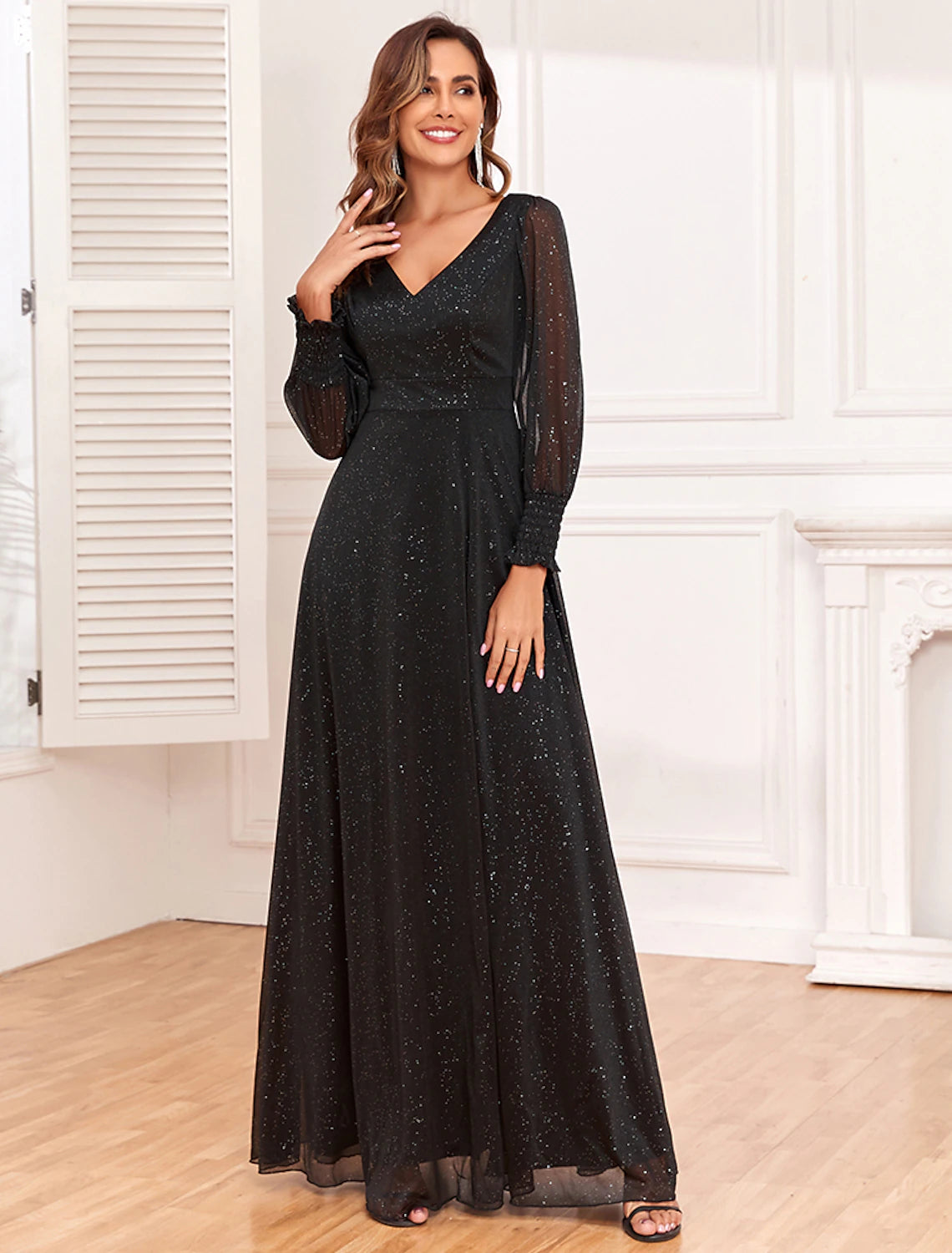 Close-up of the glitter slit on a black A-line evening gown, showing the fabric detail.