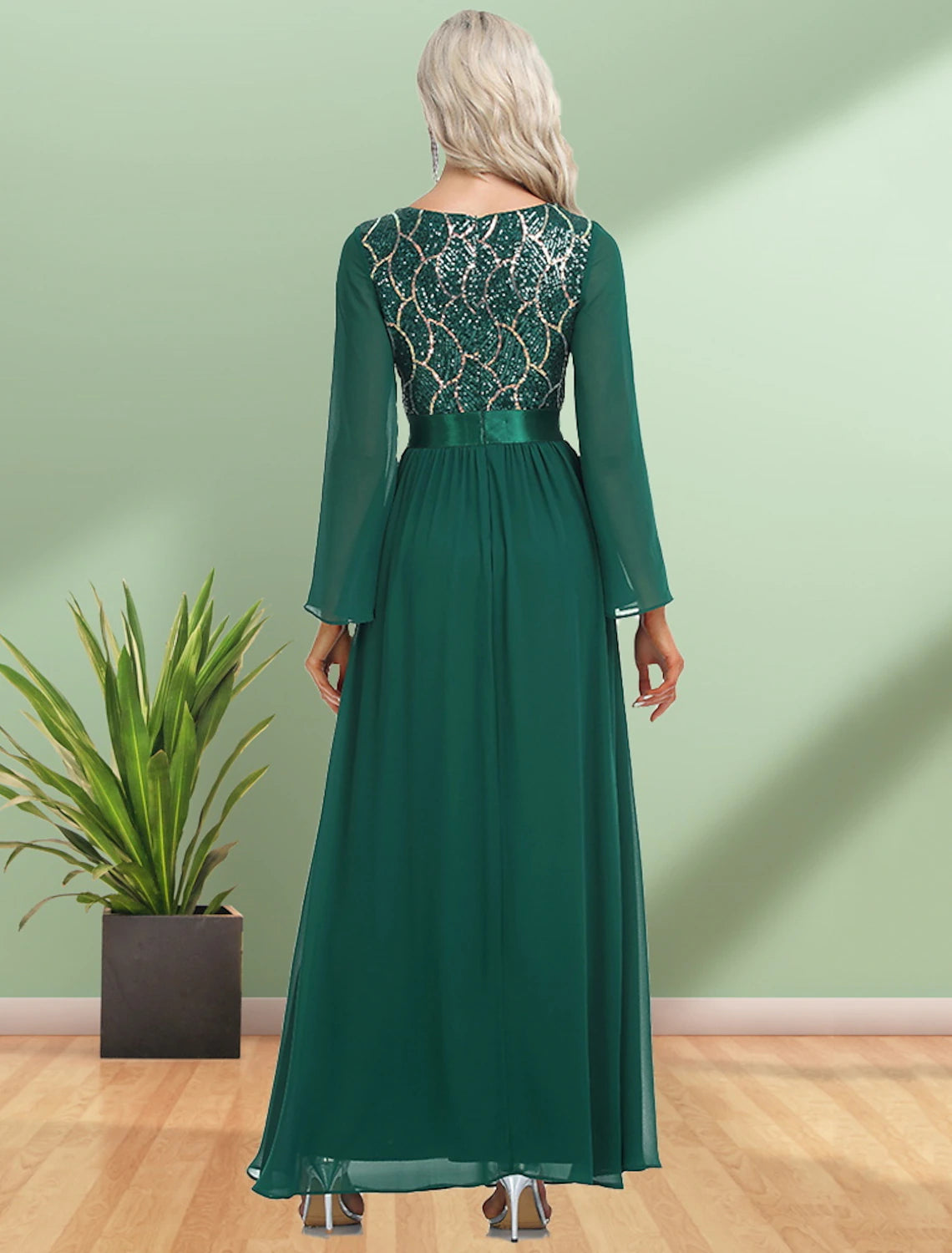 Side view of a model in a dark, floor-length sequin chiffon gown, showcasing the A-line silhouette.