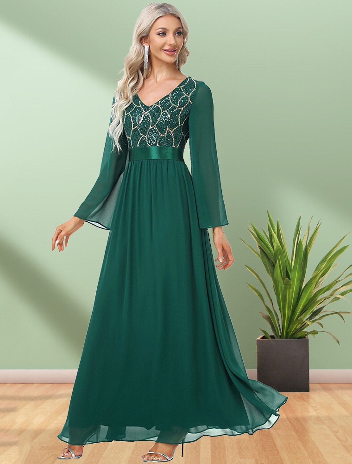 Back view of a model wearing the elegant long-sleeve V-neck evening dress with sequin details.