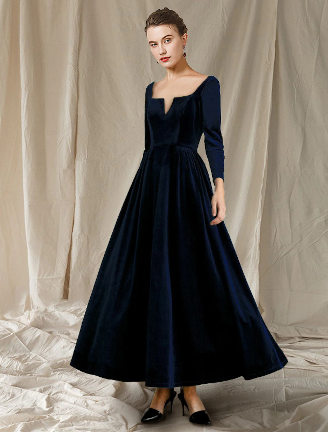 Elegant A-Line velvet dress with V-neck and long sleeves, featuring delicate pleats.