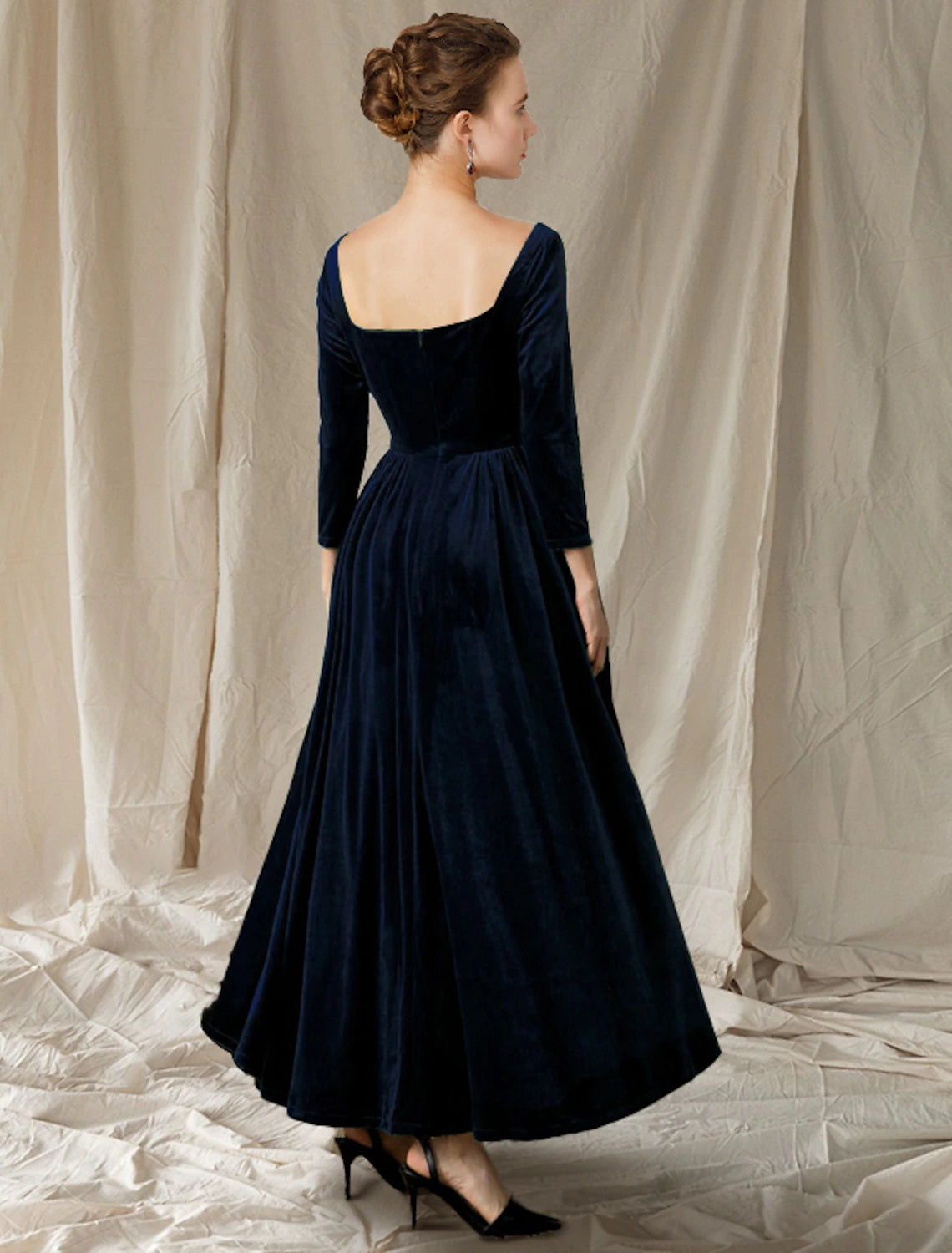 Sophisticated ankle-length velvet gown with V-neck and long sleeves, suitable for formal events.