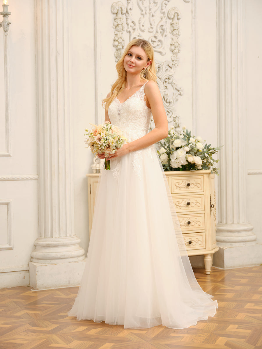 Close-up of the V-neck bodice and intricate appliques on the wedding dress.
