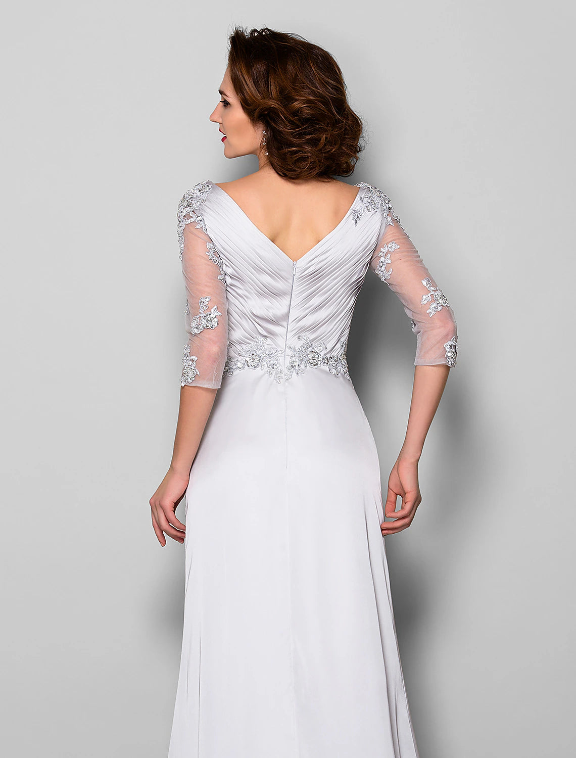 Close-up of the V-neckline and intricate beading on the bodice of the formal dress.