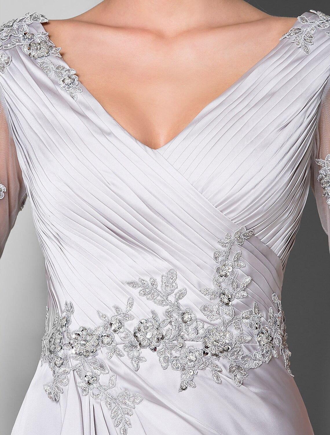 Detail of the luxurious satin chiffon fabric and the elegant drape of the skirt.