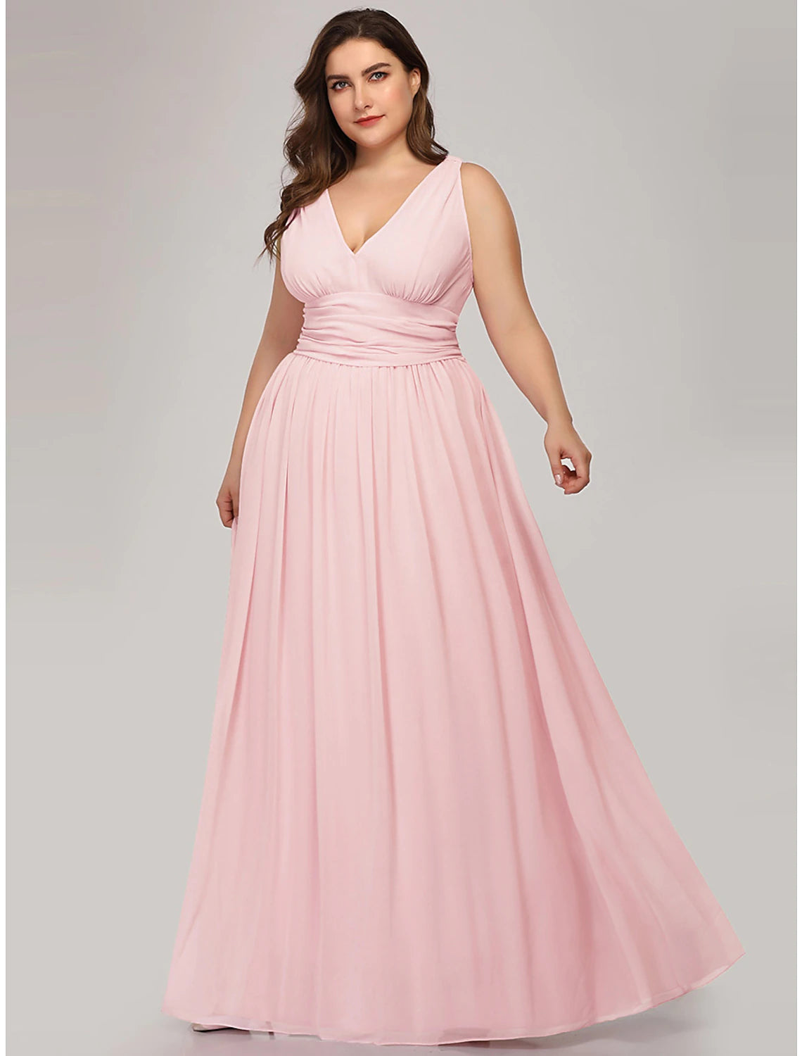 Side profile of a woman in a floor-length pleated chiffon dress.