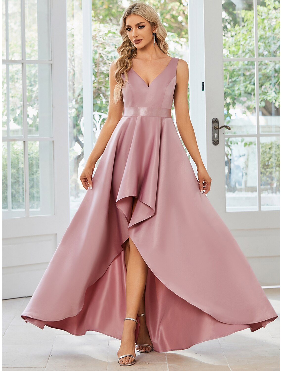 Woman wearing an elegant A-line V-neck satin dress with ruffles.