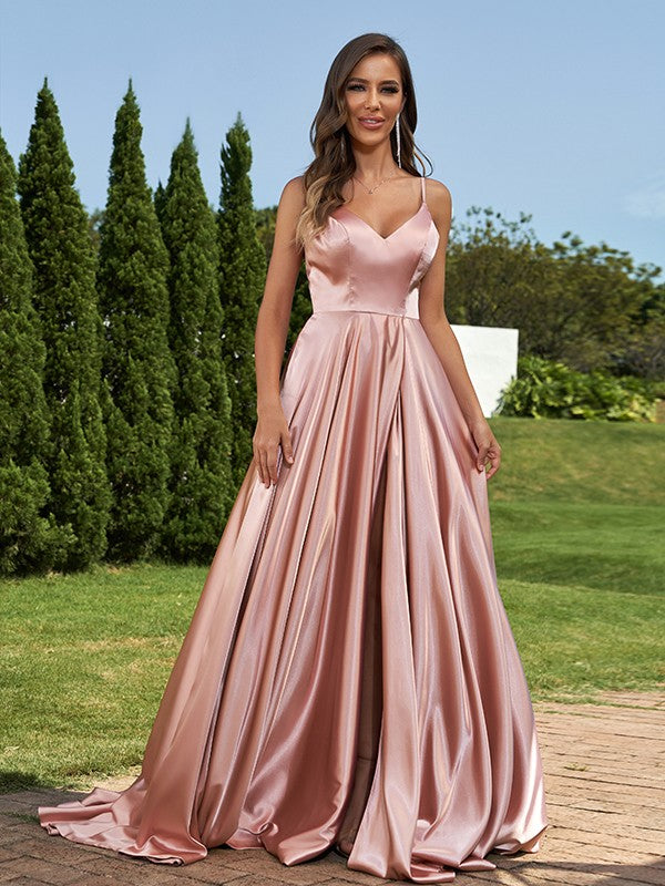 Side profile of a light pink ruffled satin bridesmaid gown.